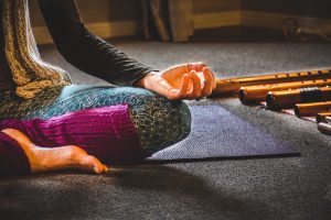 A woman sitting cross-legged practicing yoga